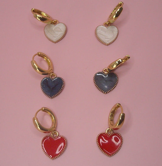 Heart Drop Earrings are exquisite earrings that feature a round huggie hoop design made from high quality brass material. The earrings are plated with real 18k yellow gold, offering a luxurious and elegant look with their sturdy and durable construction. The charming hearts are crafted using a combination of gold alloy and enamel, adding a colorful and romantic touch to these stunning earrings. Comfortable for extended periods of wearing, these Heart Drop Earrings make a perfect accessory for any occasion.